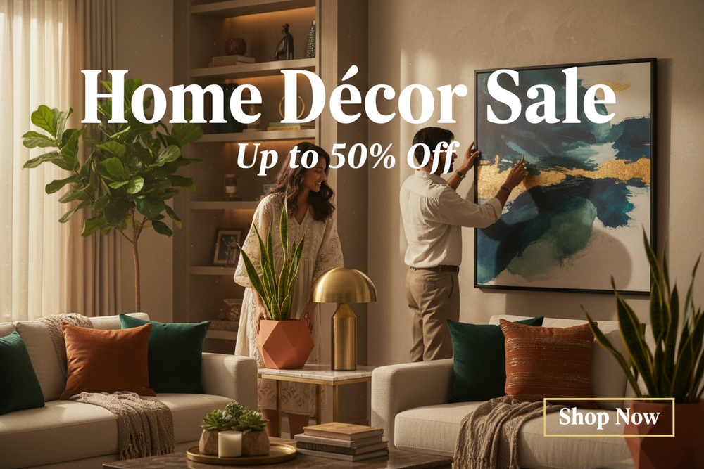 Cinematic premium e-commerce hero banner for home décor showcasing a modern Indian couple styling their living space. Elegant décor items like lamps, wall art, planters, and cushions arranged creatively. Warm ambient lighting, cozy luxury tones. Photoshop-style layout with “Home Décor Sale”, “Up to 50% Off” and a stylish “Shop Now” button.